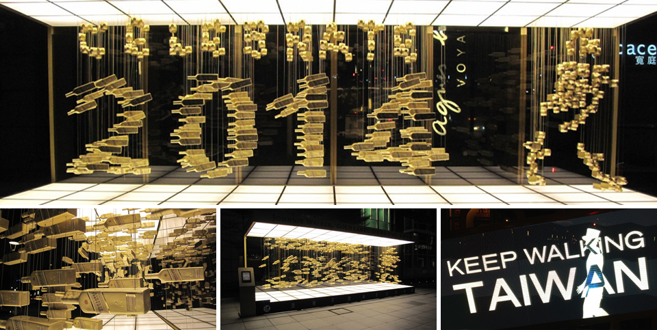 The suspended gold-bottle installation resolving into 2014 and the Striding Man in a mirrored room