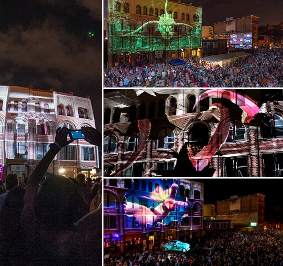 LUMA projection mapping live — animated art on the facade with a nighttime crowd